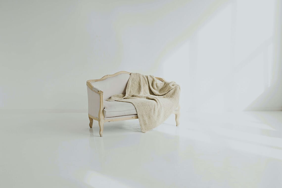 one item draped over a white sofa